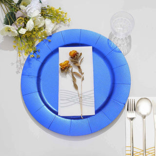 Blue decorative plate set with white napkin and dried flower arrangement.