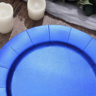 Blue textured serving plate on a wooden surface with candles.