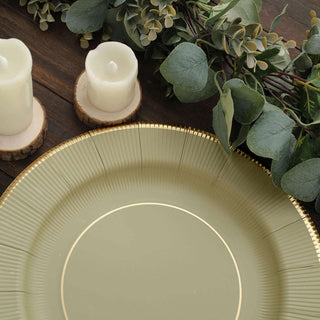 Elegant green plate with gold trim, surrounded by candles and greenery.