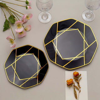 Elegant black plates with gold geometric design, styled with flowers and glassware.