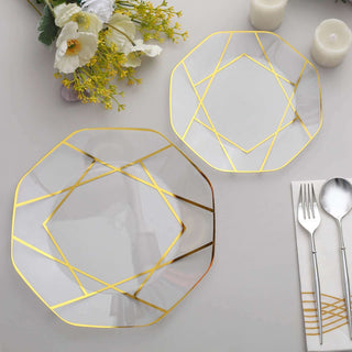 Elegant geometric glass plates with gold accents on a decorative table setting.