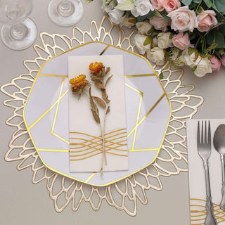 Elegant table setting with decorative plate, floral accents, and cutlery.