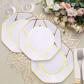 Elegant white plates with gold geometric patterns, arranged on a decorative placemat.