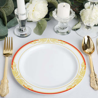 Elegant white plate with gold and red floral border, set for dining.