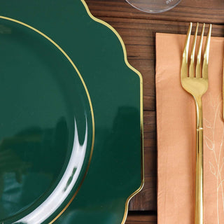 Green decorative plate with gold trim and elegant gold fork on a napkin.