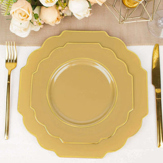 Elegant gold scalloped dinnerware set on a table with floral decor.