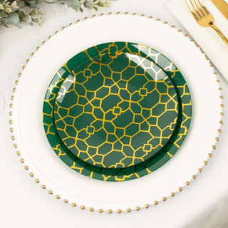 Green decorative plate with gold geometric pattern on a white table setting.