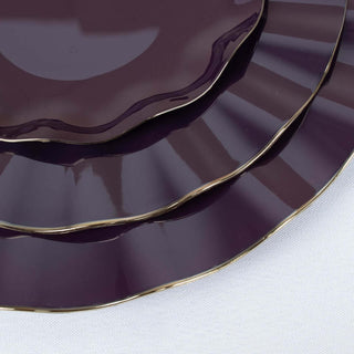 Elegant purple plates with gold trim, stacked in a studio-style shot.