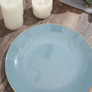 Elegant blue plate with gold rim on wooden surface.