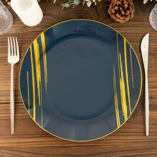 Navy blue plate with gold stripes on a wooden table setting.