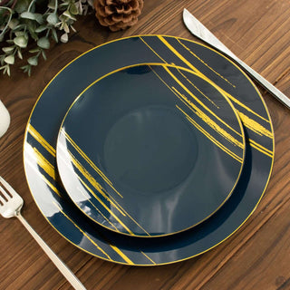 Elegant navy blue dinner plates with gold brushstroke design on wooden table.