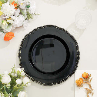 Black decorative plate with scalloped edges and gold detailing.