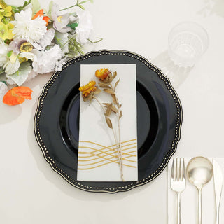 Elegant black plate with floral napkin and cutlery setting.