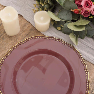 Elegant burgundy plate with gold trim on a rustic wooden table