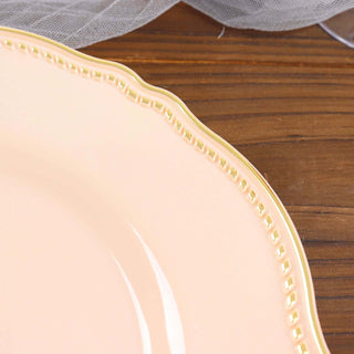 Elegant pink plate with gold trim on a wooden surface.