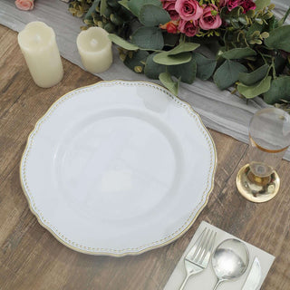 Elegant white plate with gold trim on a rustic wooden table setting.