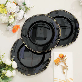 Set of three elegant black plates with gold trim.