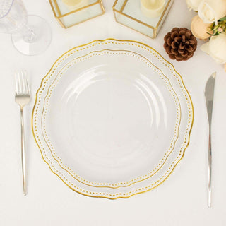 Clear glass plate with gold rim and decorative edge on a table setting.