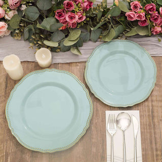 Elegant mint green plates set on a rustic wooden table with floral decor.