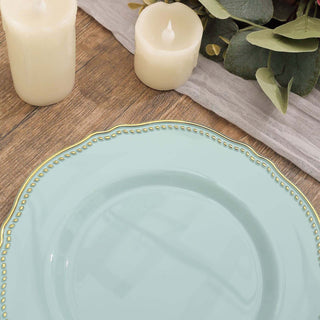 Elegant mint green plate with decorative gold rim on a rustic wooden table.