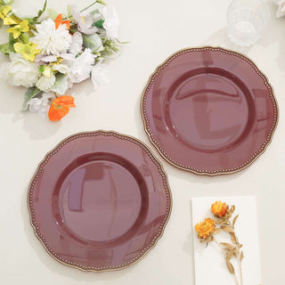 Elegant burgundy plates with decorative edges on a light surface.