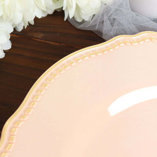 Elegant pink plate with a gold rim detail on a wooden surface.