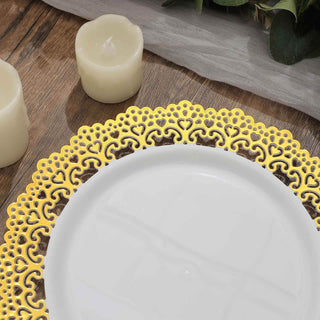 Elegant gold lace decorative plate on wooden table with candles.