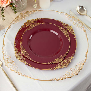 Elegant burgundy plates with gold detailing on a stylish table setting.