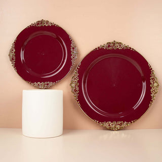 Elegant burgundy decorative plates with gold accents on a neutral background.