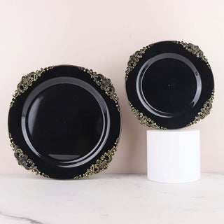 Elegant black plates with gold detailing on a white pedestal.