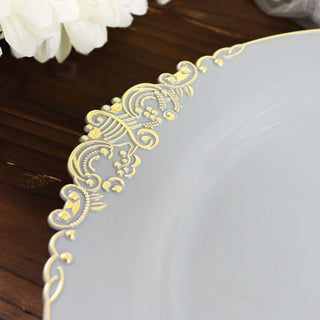 Gray plate with elegant gold floral design on the rim.