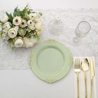 Elegant table setting with green plate, silver cutlery, and floral centerpiece.