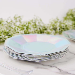 Set of iridescent octagonal plates stacked on a marble surface.