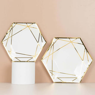 Geometric hexagon plates with gold accents on a soft pink background.