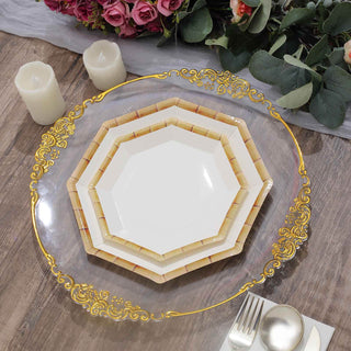 Elegant stacked plates with gold detailing on a rustic wooden table.