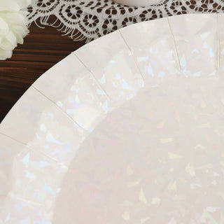 Holographic paper plate with elegant cut design on a wooden table.