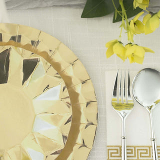 Gold decorative charger plate with silver cutlery and napkin on a textured tablecloth.