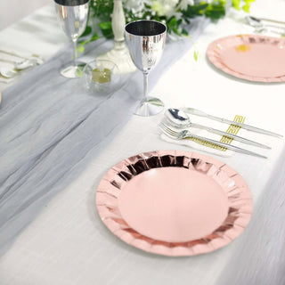 Elegant pink paper plate on a beautifully set dining table.