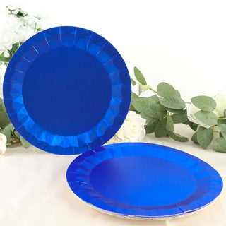 Blue paper plates with decorative edges on a soft floral backdrop.