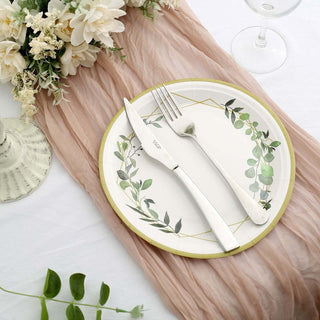 Elegant dinner plate set with knife and fork, adorned with floral design.