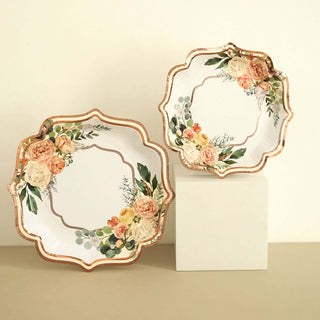Floral decorative plates with gold accents on a neutral background.