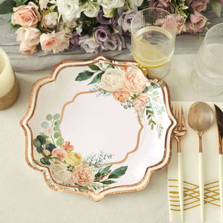 Floral patterned paper plate with gold accents on a table setting.