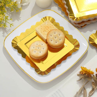 Golden decorative plates with crackers and cookies on a white background.