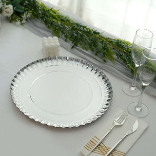 Elegant silver rimmed charger plate on a beautifully set dining table.