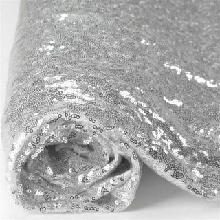 Rolled silver sequin fabric showcasing shimmering texture