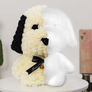Floral dog-shaped decor made of black and white roses with a bell.