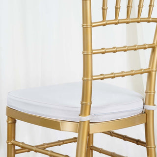 Gold chiavari chair with white cushion in studio-style isolation shot.
