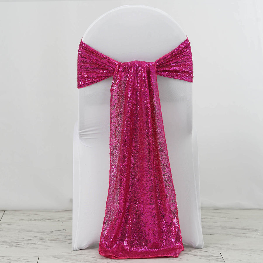Pink sequin chair sash draped elegantly on a white chair.