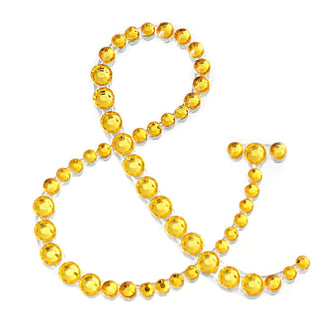 Yellow rhinestone ampersand symbol on white background