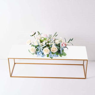 Elegant flower arrangement on a modern gold frame table.